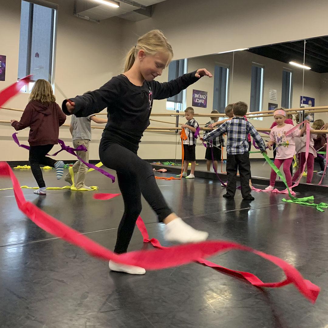 Parker Performing Arts elementary students practice ribbon dancing in a tumbling/movement class.